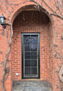 Custom black powder-coated steel security door installed on an Adelaide home by BIC Industries