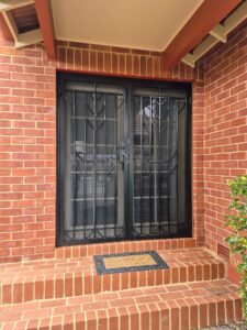 Custom black powder-coated steel security door installed on an Adelaide home by BIC Industries